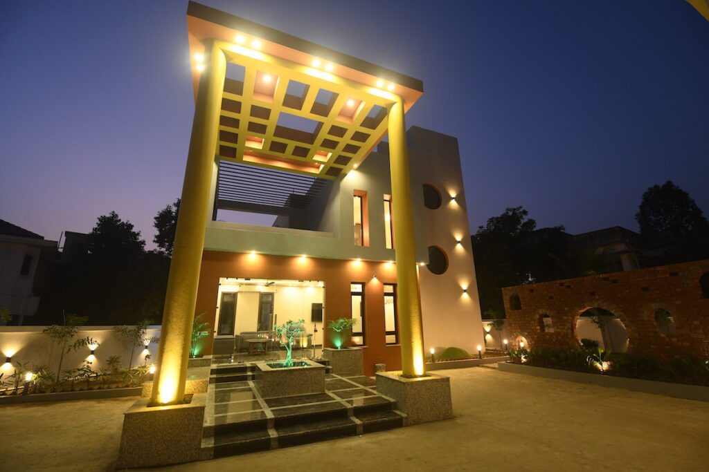 Udichi Regency with unique lighting and a landscaped entrance